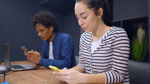Co workers use devices at work Stock Footage 112095693