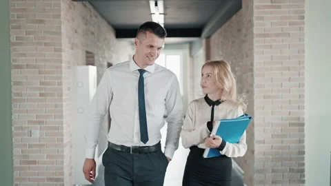 Co workers walks in the building Stock Footage 168324750