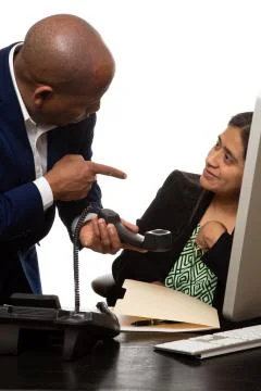 Co-Workers Working on Project and Taking a Call Stock Photos