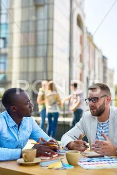 Co-working men discussing ideas outdoors Stock Photos