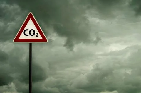Co2 on roadsign under dark cloudy sky Stock Photos
