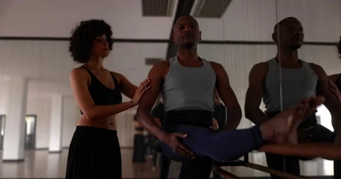 Coach adjusting male dancer pose in dance studio Stock Footage 147355739