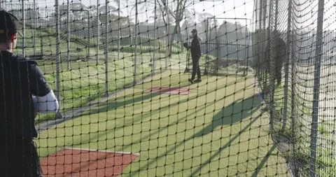 Coach and trainee bouncing ball tossing underhand and catching with glove in Vídeo Stock 343097382