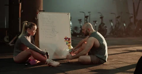 Coach and trainee drinking water from bottles Stock Footage 272373698