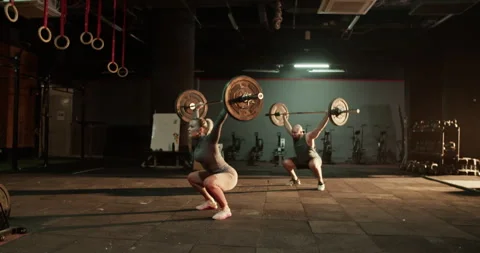 Coach and trainee lifting barbell with weights Stock Footage 272371304