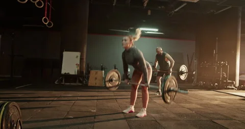 Coach and trainee training in gym with weights Stock Footage 272372964