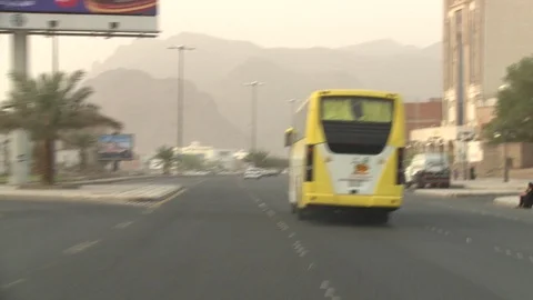 Coach bus driving toward Mount Uhud near Medina, Saudi Arabia Stock Footage 86760227
