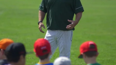 A coach is coaching boys at little league baseball practice. Stock Footage