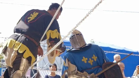 Coach cooling down Medieval Knight after combat in ring Stock Footage 116053897