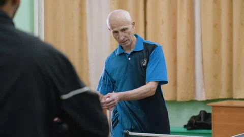 Coach Demonstrates Correct Posture for Table Tennis Training Stock Footage 319212332