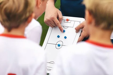 Coach explains a game strategy using a whiteboard. Anonymous football coach Stock Photos