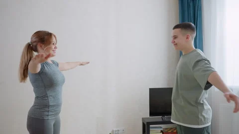 Coach Guiding Boy On Arm Stretch During Training Stock Footage 321097149
