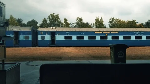 Coach of Indian train arriving at station on acloudy day. Byndoor. India. Stock Footage 106356997