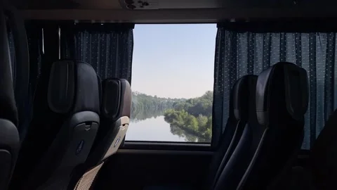 Coach interior with curtains framing changing window view from trees to, with Vídeos de archivo 344587123