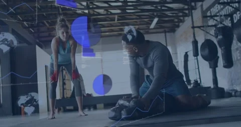 Coach kneeling checking boxing bag and gloves for training, initiating HUD data, Stock Footage 330577655