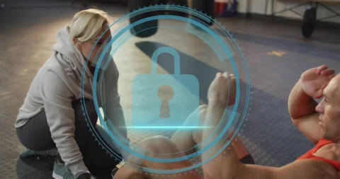 Coach kneeling cueing client counting reps, cyber security lock icon pulsing and Stock Footage 317841847