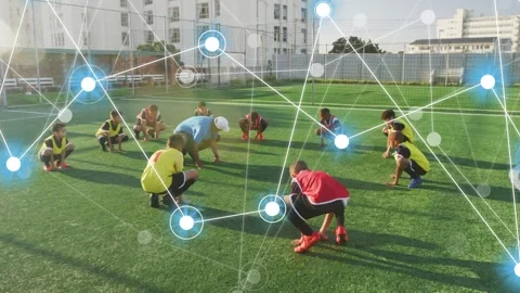Coach leading low-squat drill, team mirroring for soccer warmup as node overlay Stock Footage 334013701