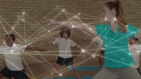 Coach leading PE class, reaching, guiding alignment, kids adjusting on blue mats Stock Footage 333414181