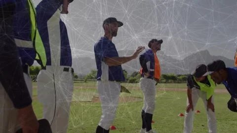 Coach placing hand on player and guiding stance correction on infield in Stock Footage 317799902