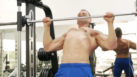 Coach shows the correct performance of the exercise for the teenager in the gym Video stock 162943303