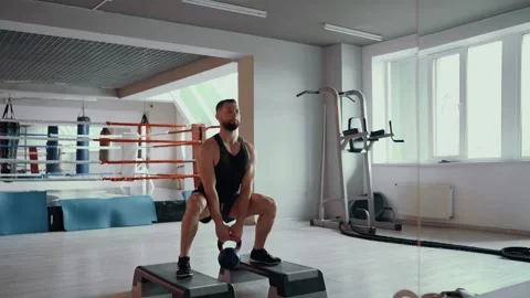The coach shows how to correctly perform the positions with a dumbbell in his Stock Footage 156479025