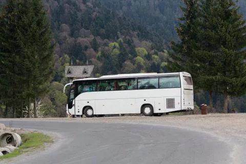 Coach stands at the turn of the mountain road Stock Photos