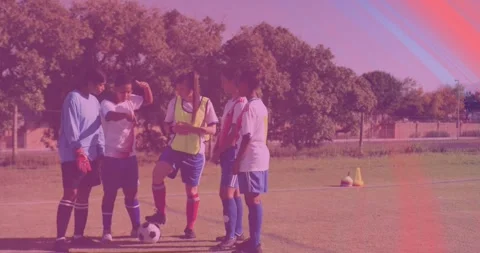 Coach tapping tablet starting soccer drills players nodding as glitches sweeping Stock Footage 327196705