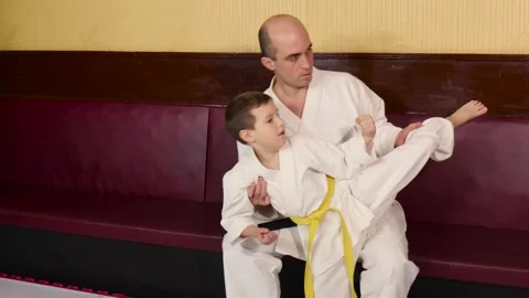 A coach teaches an athlete how to throw a circular kick Stock Footage 268718653