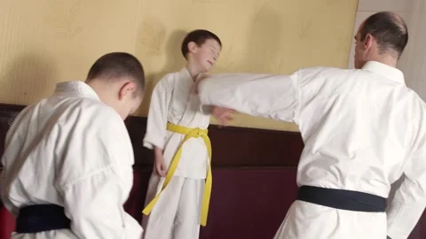Coach tying belts to students Stock Footage 268830165
