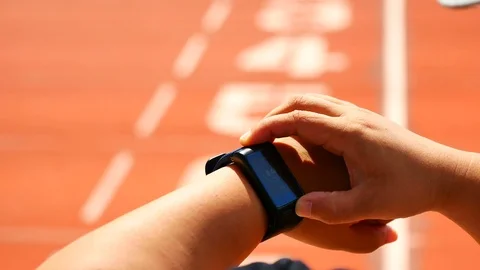 Coaches use the stopwatch Keep Athletes running statistics During  Athletes a Stock Footage 95030660