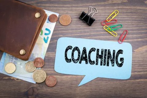 Coaching concept. Speech Bubble on a dark textured wooden background Stock Photos