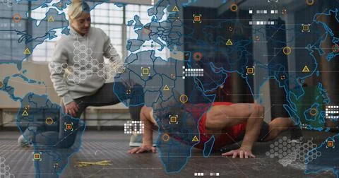 Coaching trainer kneeling gray top guiding man red top doing pushups in gym Stock Photos
