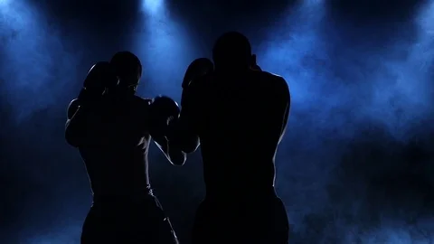 Coaching two male boxers filmed in slow motion and silhouette Stock Footage