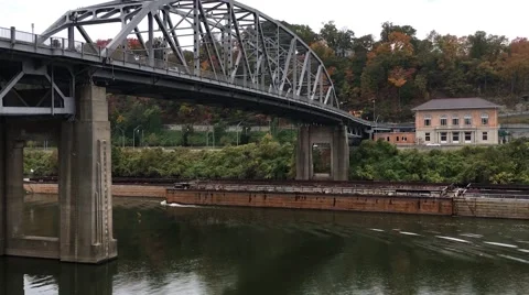 Coal Barge floating under old bridge Stock Footage 63962886