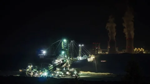 Coal digger with coal fired power plant in the background at night timelapse Stock Footage 84254036