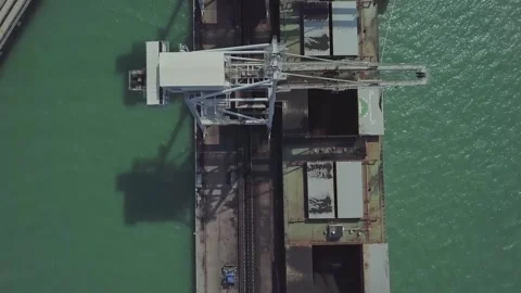 Coal Discharge Process from Cargo Ship at Jetty Terminal - Drone Shot 動画素材 333728571