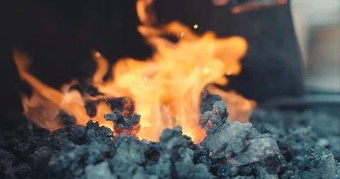 Coal on fire to light a forge Stock Footage 105296676