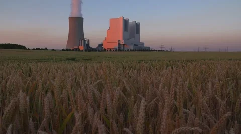 Coal-fired power station surrounded by grain fields at Sunset - Tilt Stock-Footage 52998650