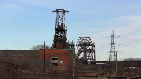 Coal mine pit head wheel abandoned derelict indsustry Stock Footage 85897598