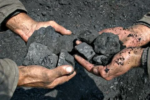 Coal miner in the hands of Stock Photos