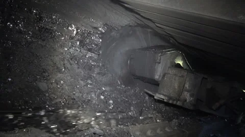 Coal miner produces coal. Coal mining in a real mine Stock Footage