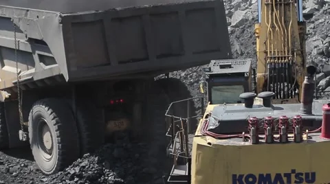 Coal mining and loading dump truck by hydraulic excavator in open pit Stock Footage 45798823