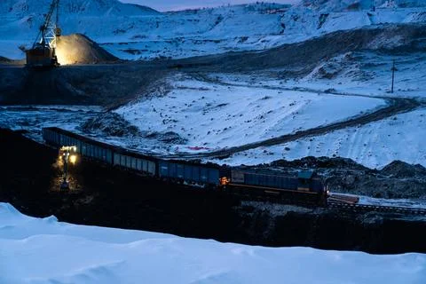 Coal mining at an open pit. Coal mine in winter covered with snow. Russia Stock Photos