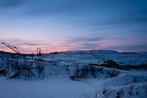 Coal mining at an open pit. Coal mine in winter covered with snow. Russia Stock Photos