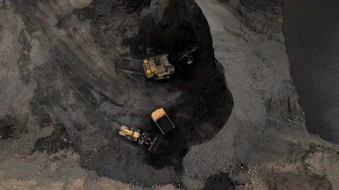 Coal mining in an open pit. Mining excavator loads coal in haul truck in quarry. Stock Footage 194009019