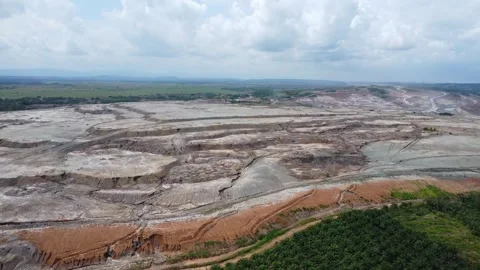 Coal mining surrounded by oil palm plantations looks very barren Stock Footage 274381816