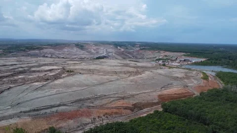 Coal mining surrounded by oil palm plantations looks very barren Stock Footage 274381883