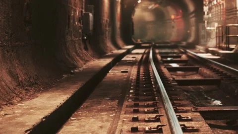 Coal mining tracks and equipment in an underground tunnel during daytime Stock Footage 344391319
