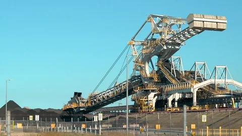 Coal scooping machine loading coal from a stockpiling field Stock Footage 96082481