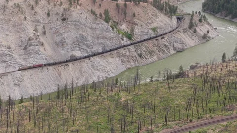 Coal Train Entering Tunnel Along Curved Gorge Wall in Fraser Canyon Stock Footage 345984487